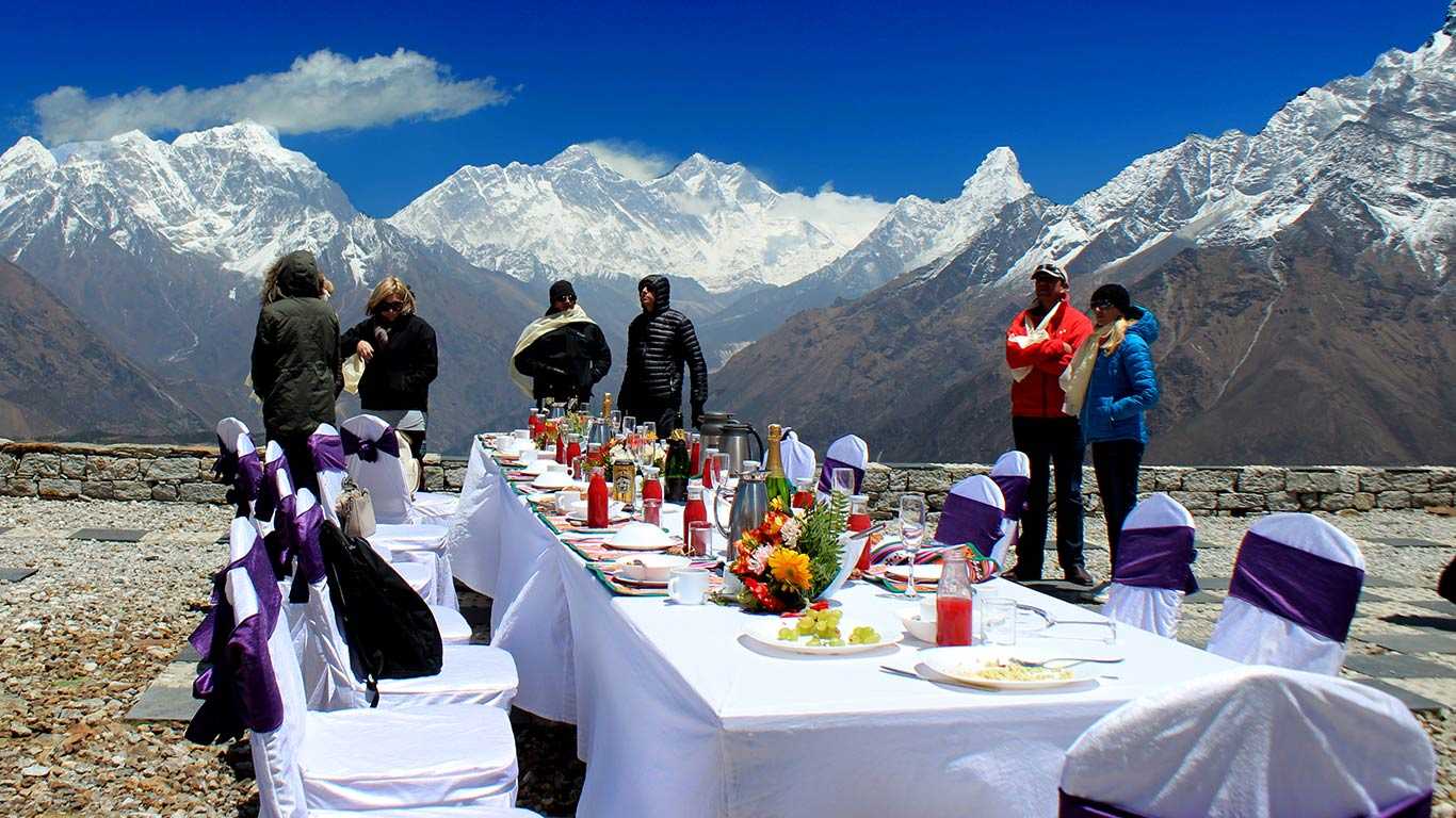 A Group of Travelers Having Champagne Breakfast at Kongde in the lap of Everest